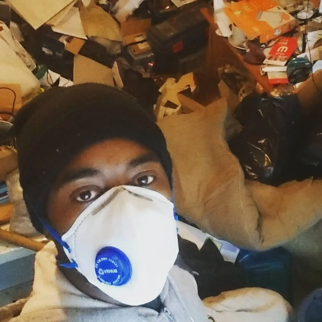 Bio Hazard Cleaning Huddersfield Halifax Leeds - a masked team member in protective equipment inside a property before it is cleared and decontaminated